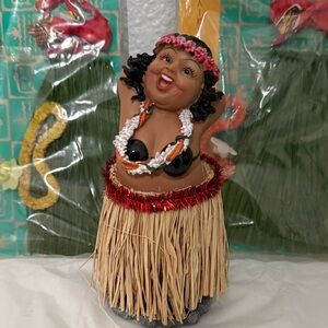 Hula Dancer Figurine with Grass Skirt includes two  grass skirt outfits.